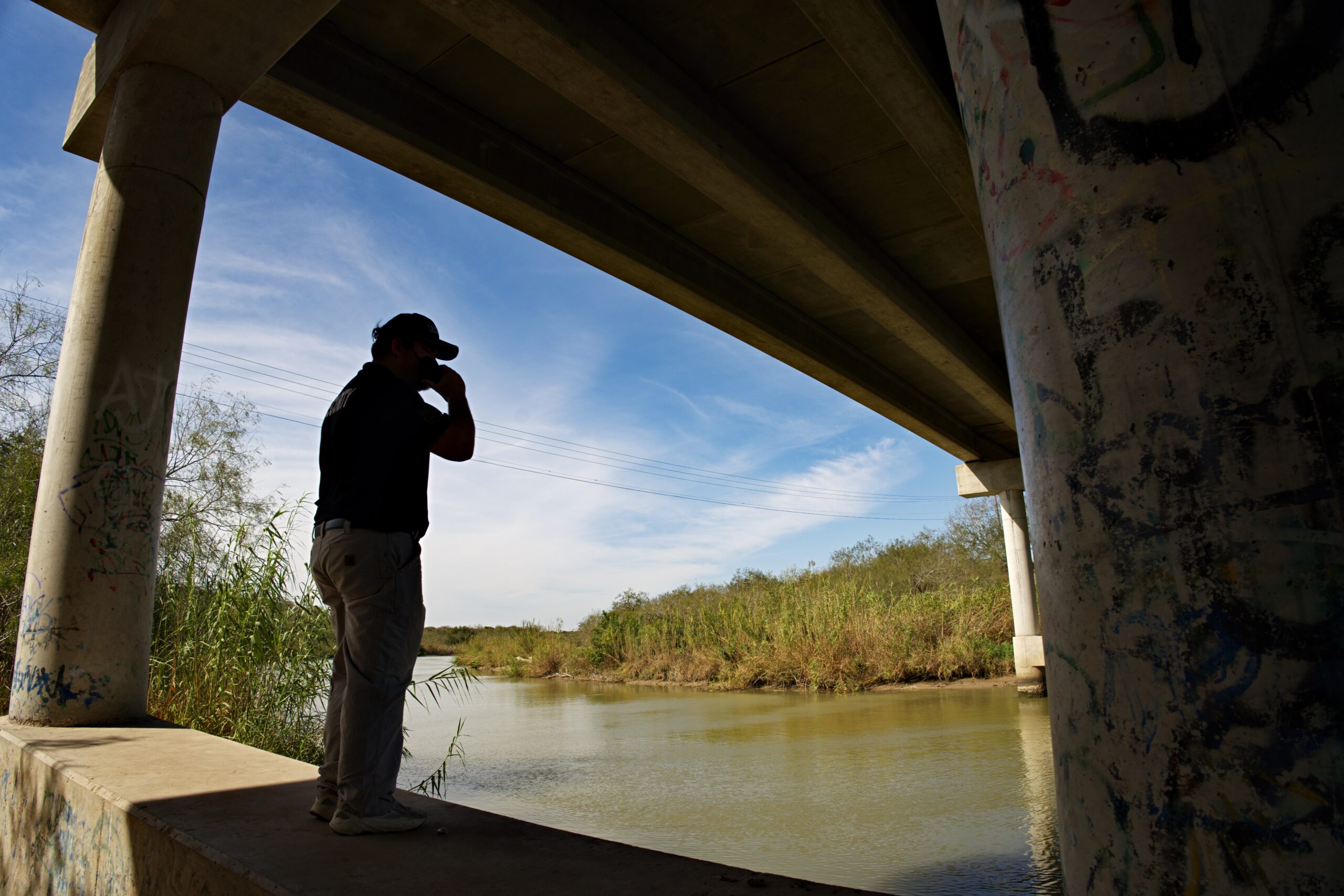 Security professional observing manufacturing facility perimeter and surrounding area in Louisiana.